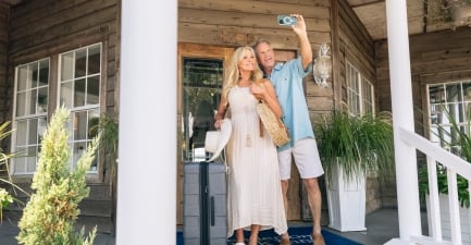 Couple takes a selfie at the front door