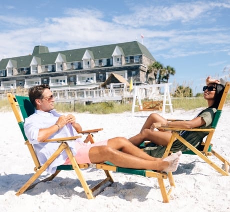 Couple facing each other reclined in beach chair