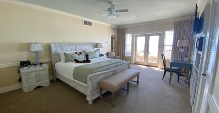 A coastal hotel suite with a king bed and balcony
