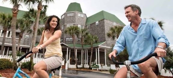 Couple smiling while biking together