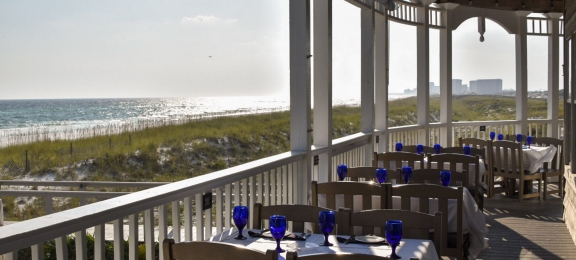 Outdoor dining setup with blue wine glasses
