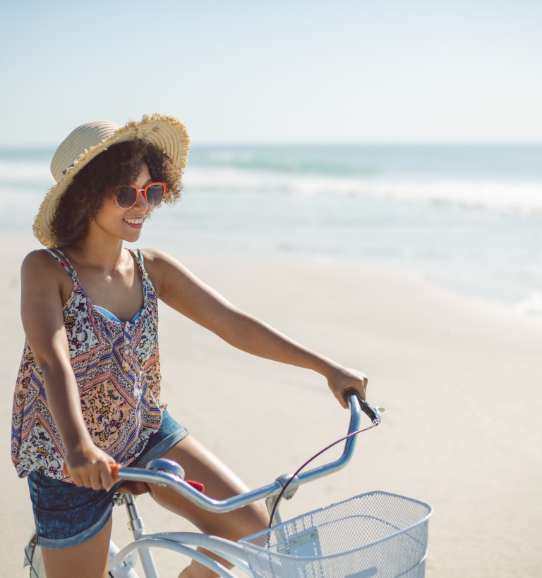 Girl on bike on beach