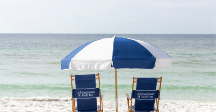 2 beach chairs umbrella centered