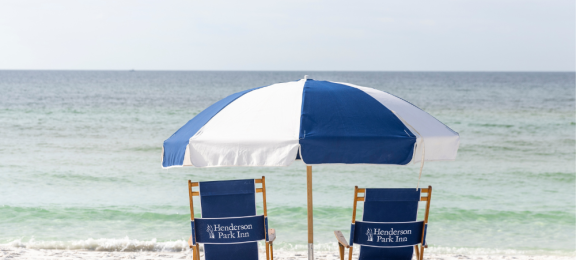 2 beach chairs umbrella centered