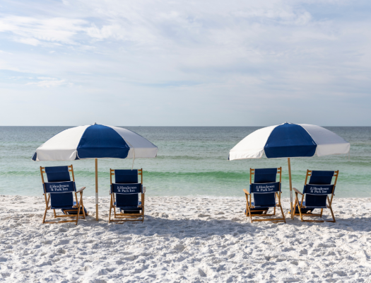 4 beach chairs with umbrellas