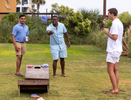 boys playing cornhole