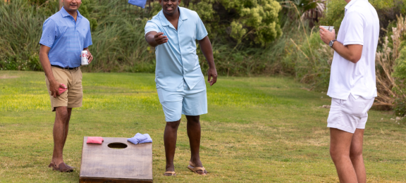 boys playing cornhole